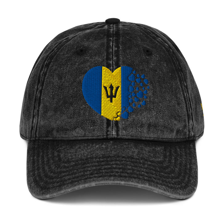 Black Barbados themed vintage classic cap which features the Barbados flag inserted into the shape of a heart.

Barbados Flag Breakdown:
The blue represents the sea and sky surrounding the island.
The gold represents the sand and sun of Barbados’ beaches.
The black broken trident symbolizes breaking away from its colonial past and becoming independent in 1966.