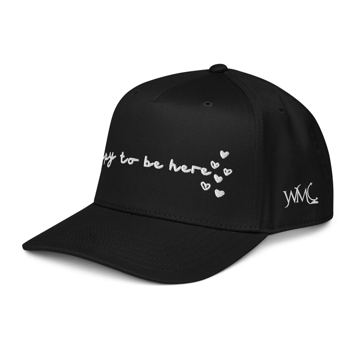 Five panel black Otto cap with the words Happy To Be Here embroidered in black font on the front of the cap. Built on a classic 5-panel Otto cap, it has that structured front and comfortable fit that hat lovers appreciate. It’s lightweight, easy to wear, and effortlessly cool for everyday adventures.