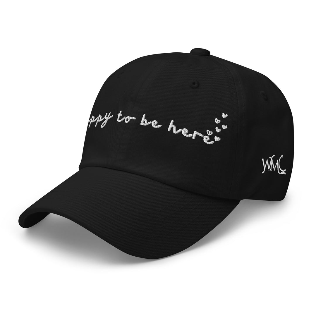 Classic cap with the words Happy To Be Here embroidered in white on the front of the cap. The design is accompanied by rising hearts at the end of the quote. This cap represents just enjoying the moment whether that be nature, the beach, a concert or your favorite restaurant.