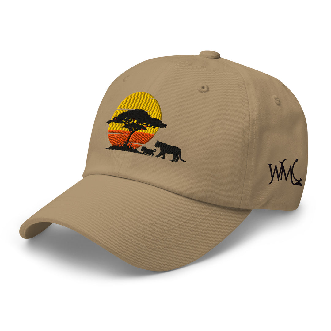 Khaki colored classic cap with an embroidered design of an acacia tree, a female lion and a lion cub against the backdrop of sunrise, on the front the cap.