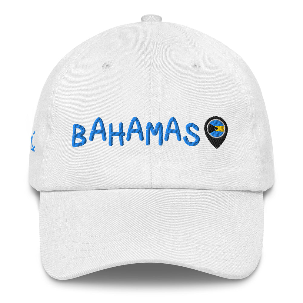 This white classic cap features BAHAMAS elegantly embroidered in light blue font across the front, paired with a location icon showcasing the vibrant colors of the Bahamian flag.
