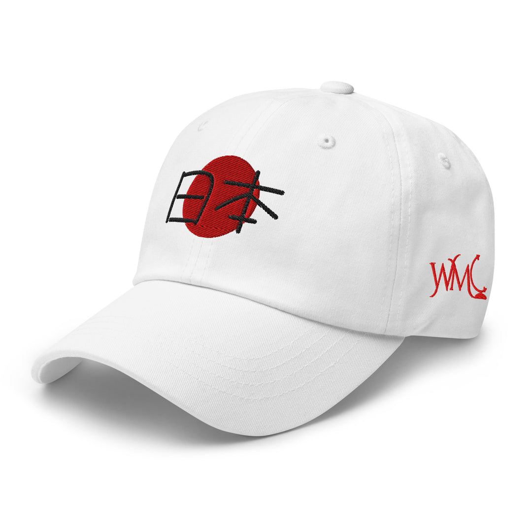 White classic cap with the Japanese flag embroidered on the front along with the word Japan in Japanese letters. This cap features an antique adjustable buckle closure.