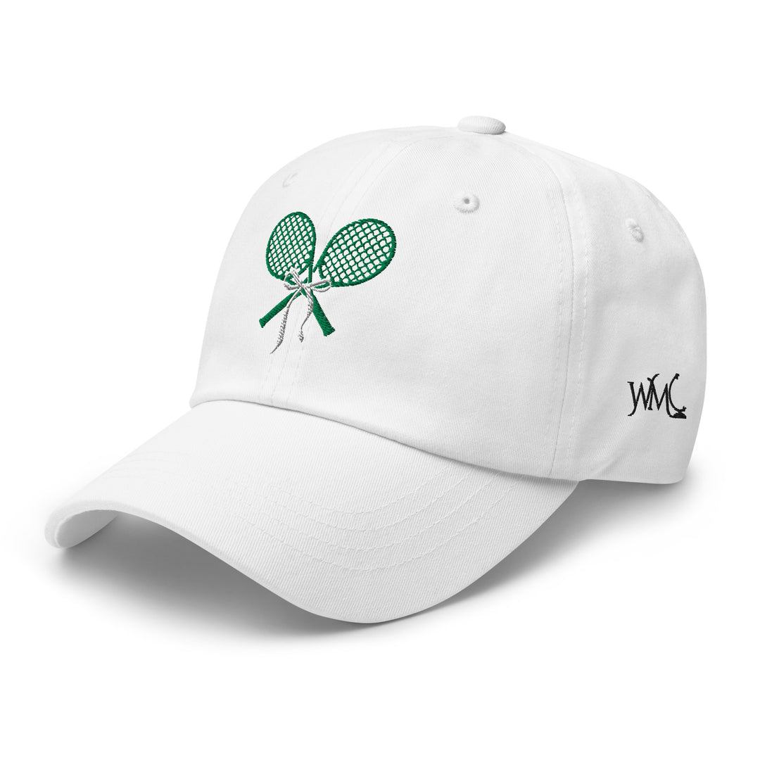 Serve up classic style with this white classic cap featuring two green embroidered tennis rackets, a nod to the timeless elegance of Wimbledon. Inspired by the prestigious tournament's all-white dress code, grab one of these caps on your next trip to Europe.